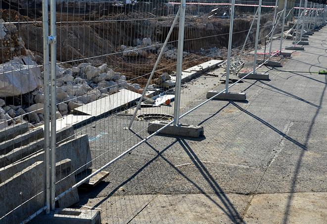 an orange temporary fence panel used to block off an area on a job site